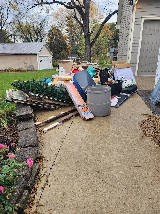 Dumpster being loaded with debris for Roofing Dumpster Rental in Corning